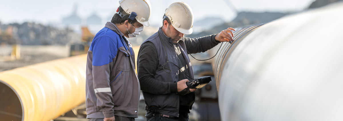 Two men from Buffalo Inspections conducting welding inspections