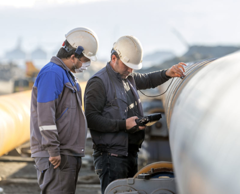 Two men from Buffalo Inspections conducting welding inspections
